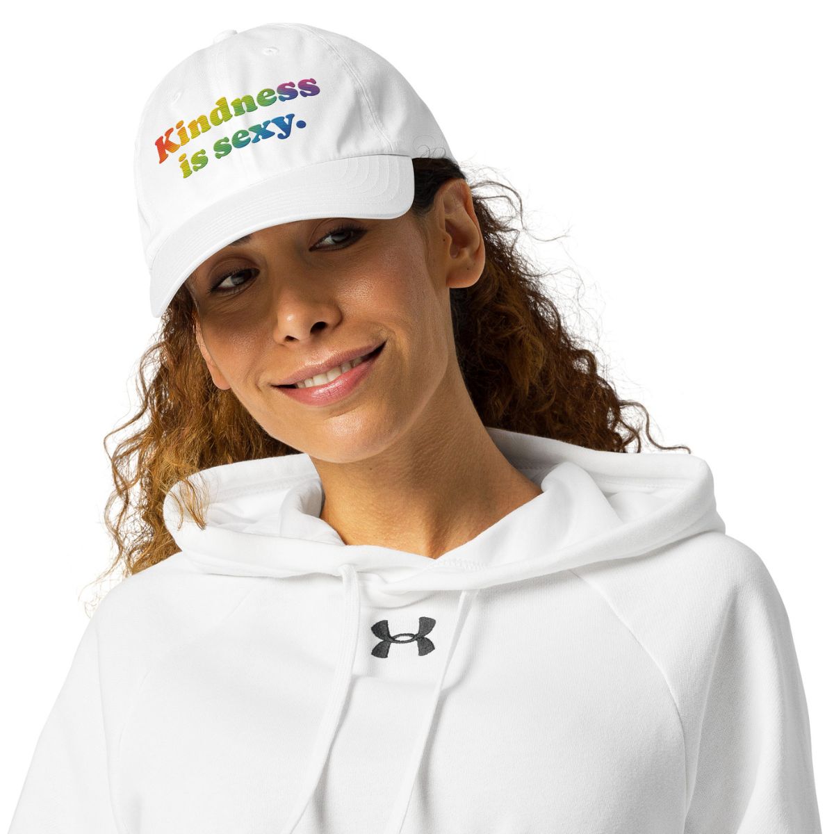 Person wearing a white cap with colorful text and a white hoodie with a logo, on a white background